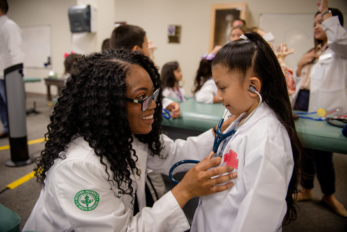 Western University of Health Sciences students from the Pediatric Interest Group hosted about 40 children - who were mostly kindergarten students - for the school’s inaugural Mini-Medical School at the Pomona campus, Saturday, Sept 22, 2018. Second-year College of Osteopathic Medicine of the Pacific student Vivian Okonta shows kindergarten student Claudia Reyes, of Pomona, how to use a stethescope. Kindergarteners learned about the human body and medicine through four stations taught by WesternU students: Bone station, heart and pulse station, hand hygiene station and mini operating room.